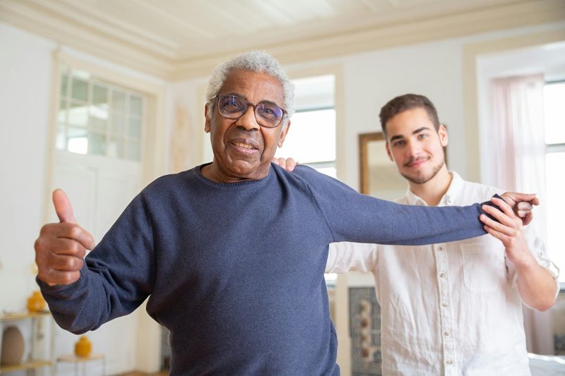 Caregiver helping older man with physical activity | Home Care Jobs Philadelphia | Neighborly Home Care